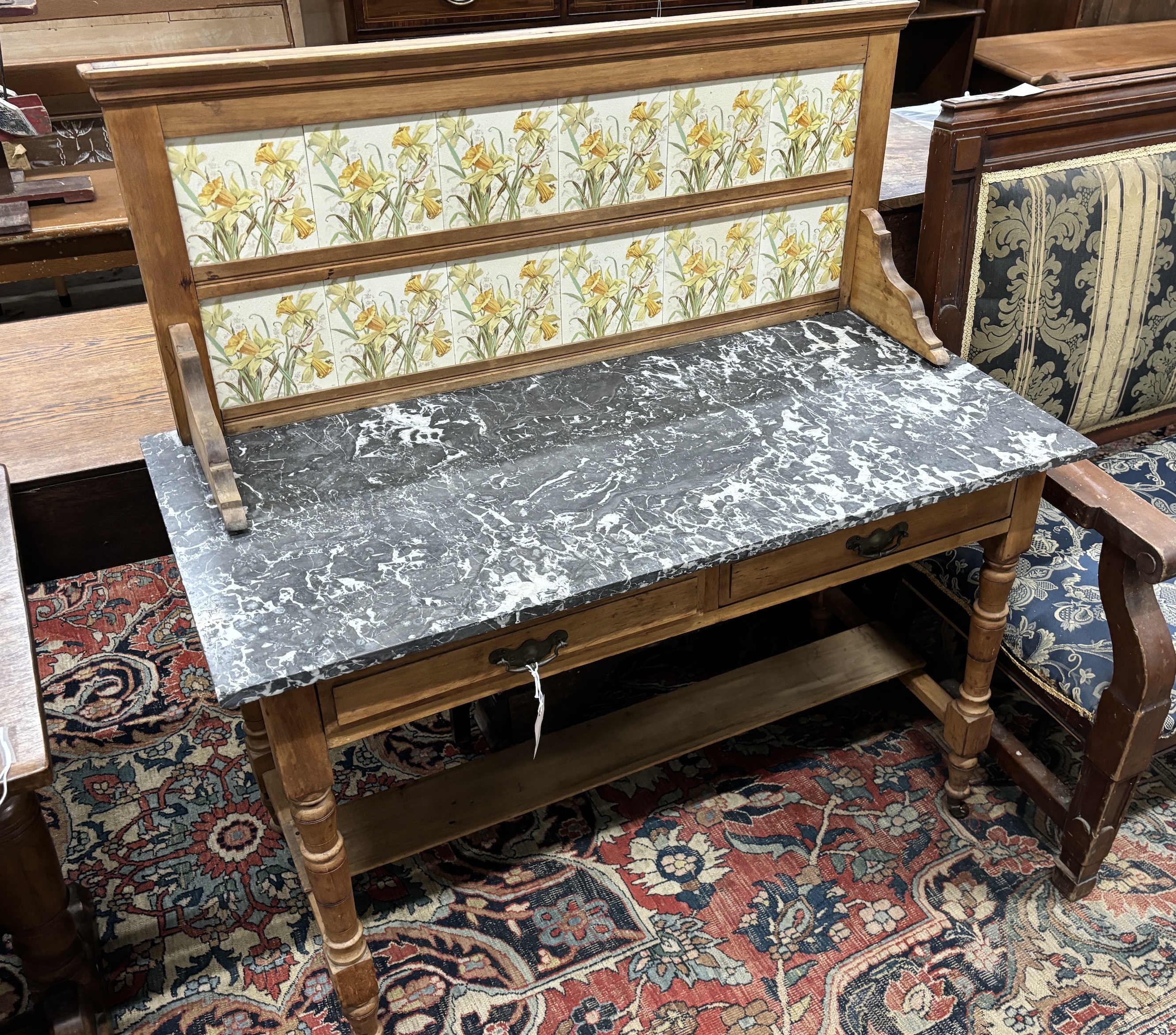 A late Victorian pine marble topped tiled back washstand, width 107cm, depth 51cm, height 116cm